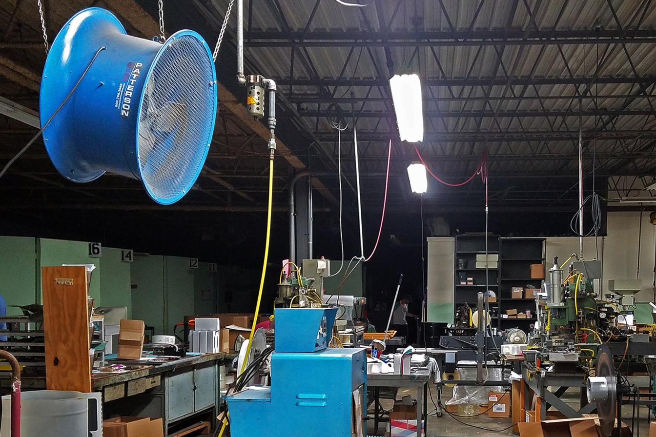 Patterson barrel fan suspended in a working shop